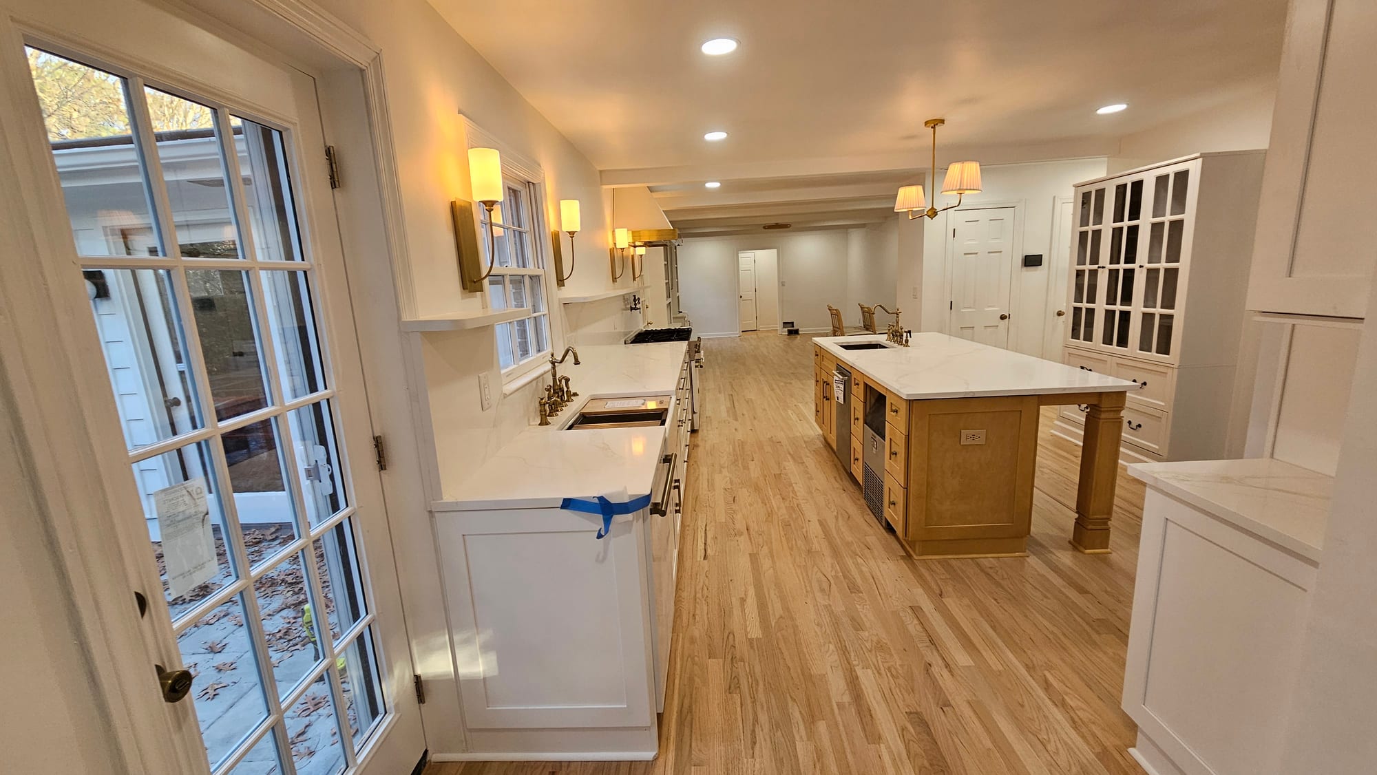 Renovated kitchen, long view toward the front hall and built-in china cabinet