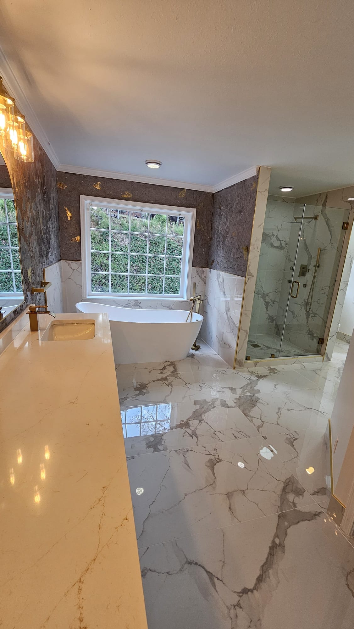 Primary bathroom with a freestanding tub and frameless glass shower