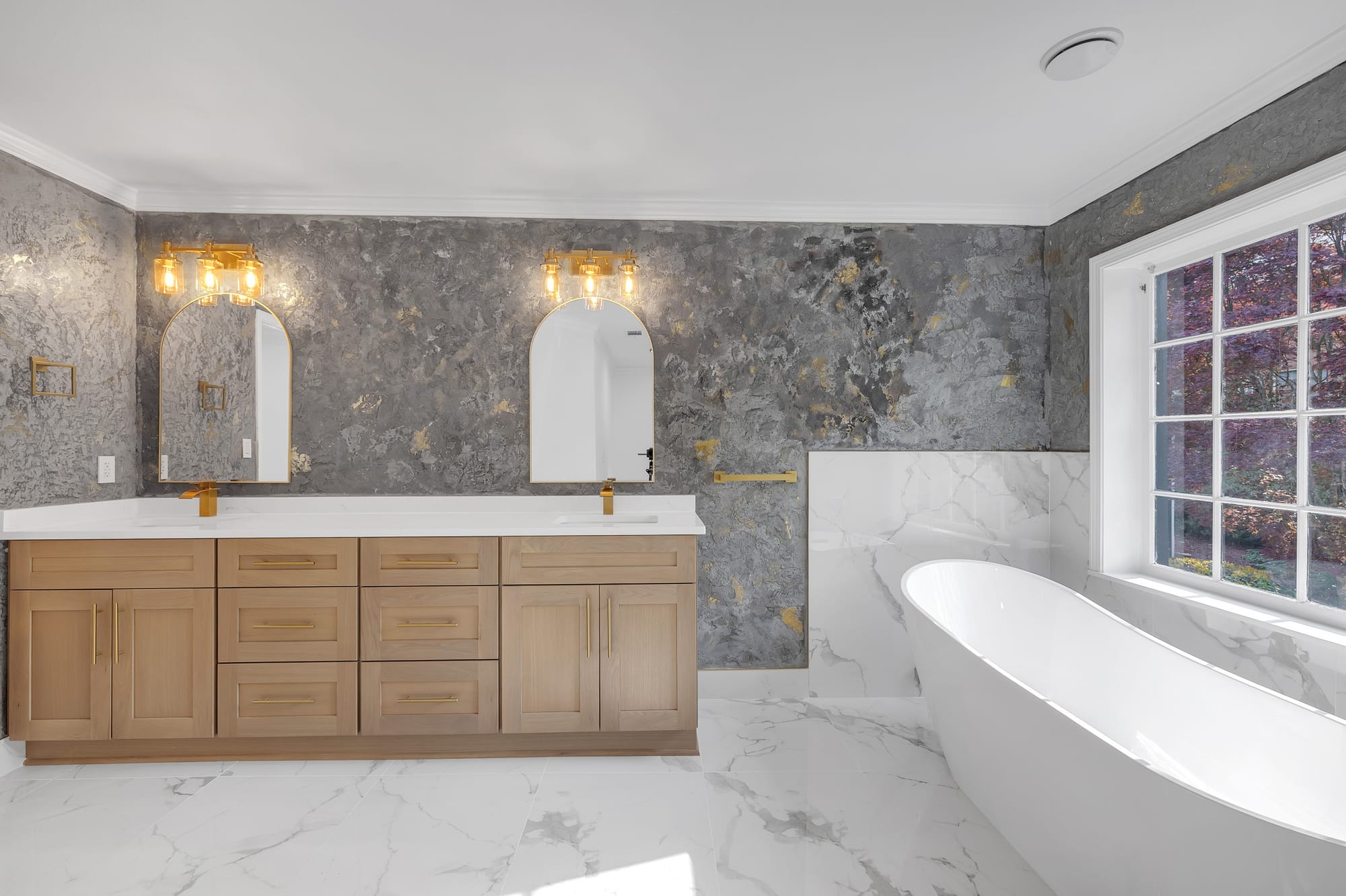 Primary bathroom with a Venetian plastered wall behind a freestanding tub