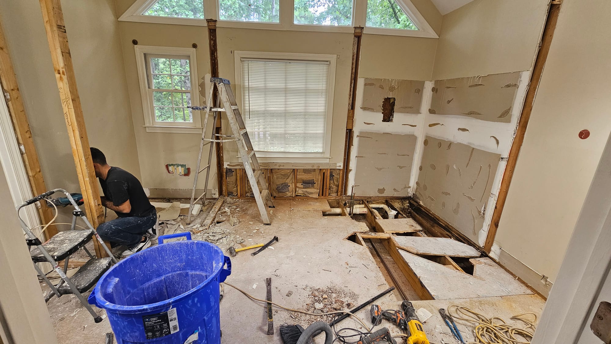 Primary bathroom gutted to exposed studs and subfloor, under construction